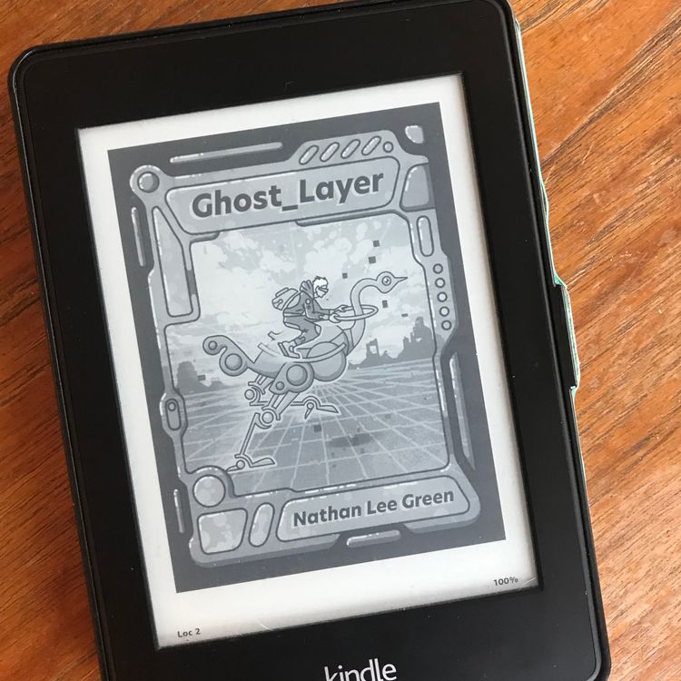 A Kindle device showing the cover of my future Ghost_Layer ebook.